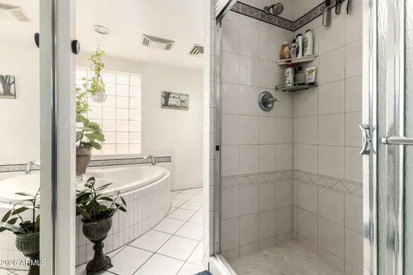 a bathroom with a bathtub and shower