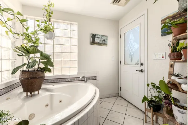 a bath tub sitting in a bathroom next to a window
