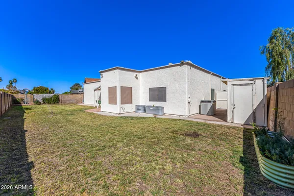 a view of a house with a backyard