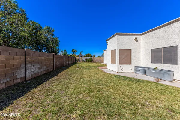 a view of a backyard with wooden fence