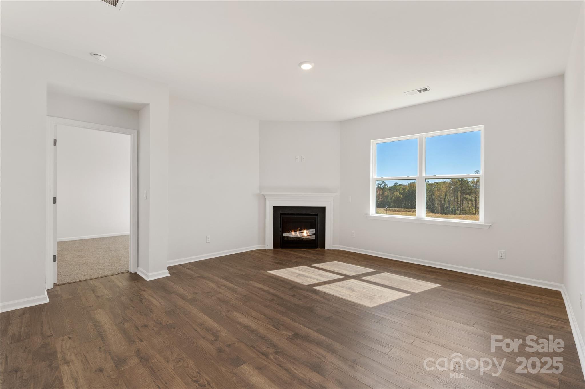 181 Salers Road Fletcher, NC 28732 - Photo 9 of 24 an empty room with windows and a fireplace