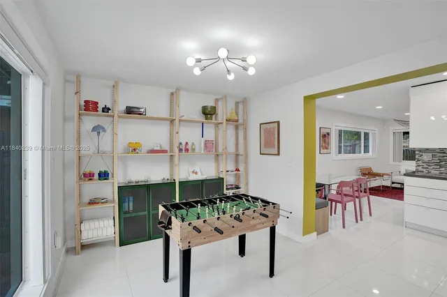 a dining room with furniture and kitchen view