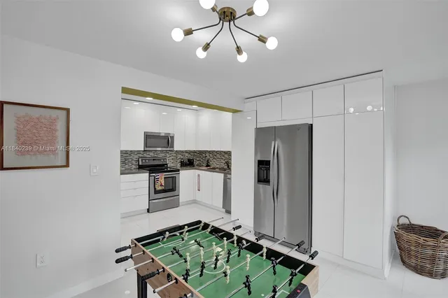 a kitchen with stainless steel appliances a stove a refrigerator and cabinets