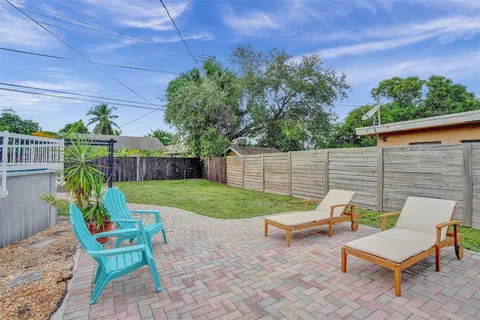 a view of backyard with seating space and trees