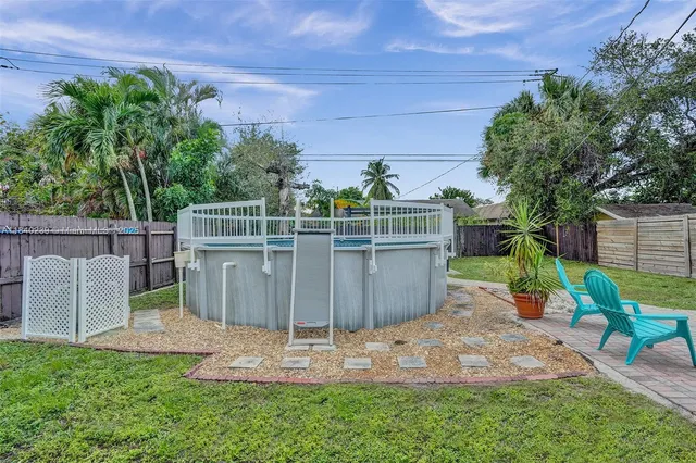 a view of a backyard with wooden fence