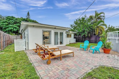a view of a house with backyard sitting area and garden