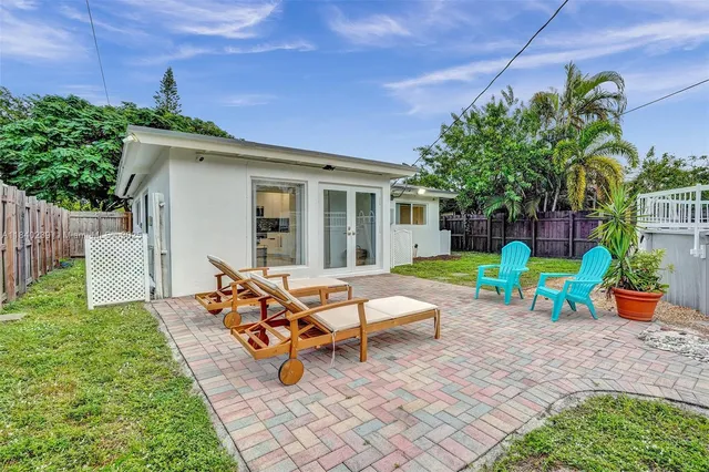 a view of a house with backyard sitting area and garden