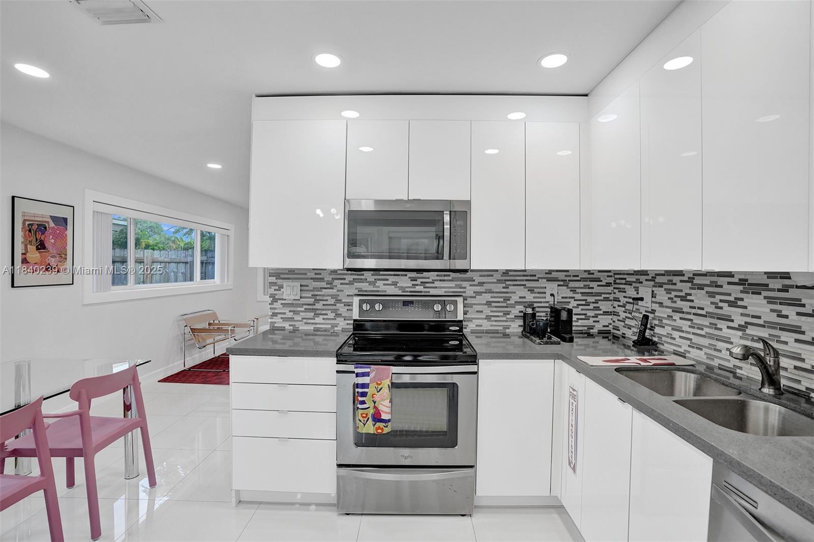1605 Northwest 7th Terrace Fort Lauderdale, FL 33311 - Photo 4 of 33 a kitchen with a sink stove top oven and cabinets