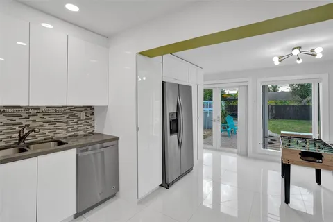 a kitchen with stainless steel appliances granite countertop a refrigerator and a stove