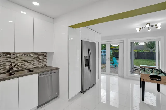 a kitchen with stainless steel appliances granite countertop a refrigerator and a stove