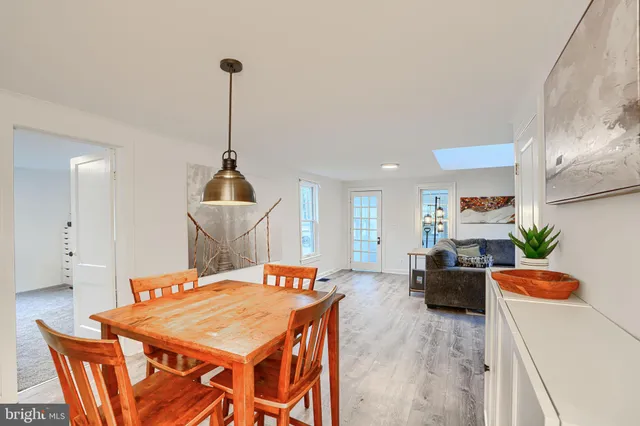 a dining room with furniture a window and a chandelier