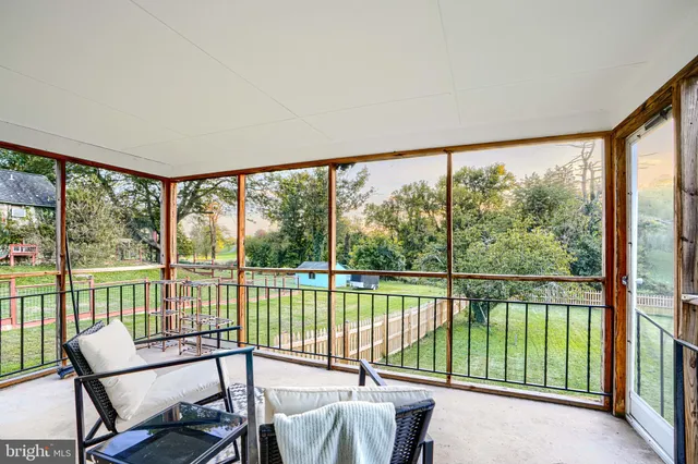 a living room with a bed furniture and a book shelf
