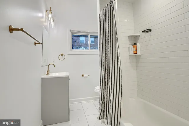 a bathroom with a sink a mirror and a shower