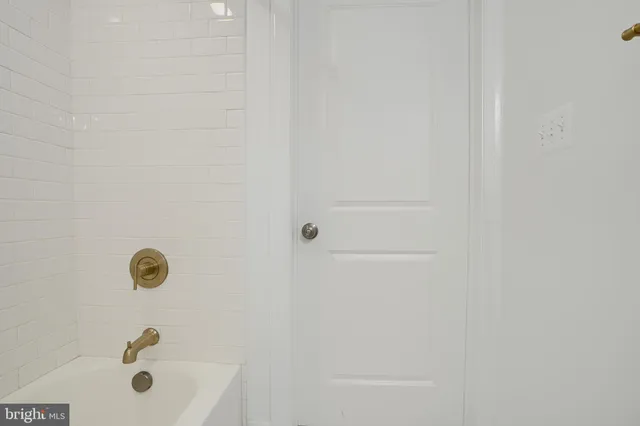 a bedroom with a bed and a ceiling fan