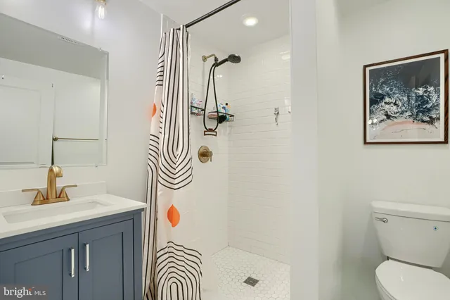 a bathroom with a sink a mirror and a shower
