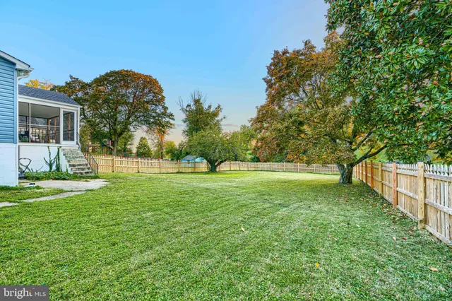 a view of a yard with a house in the background