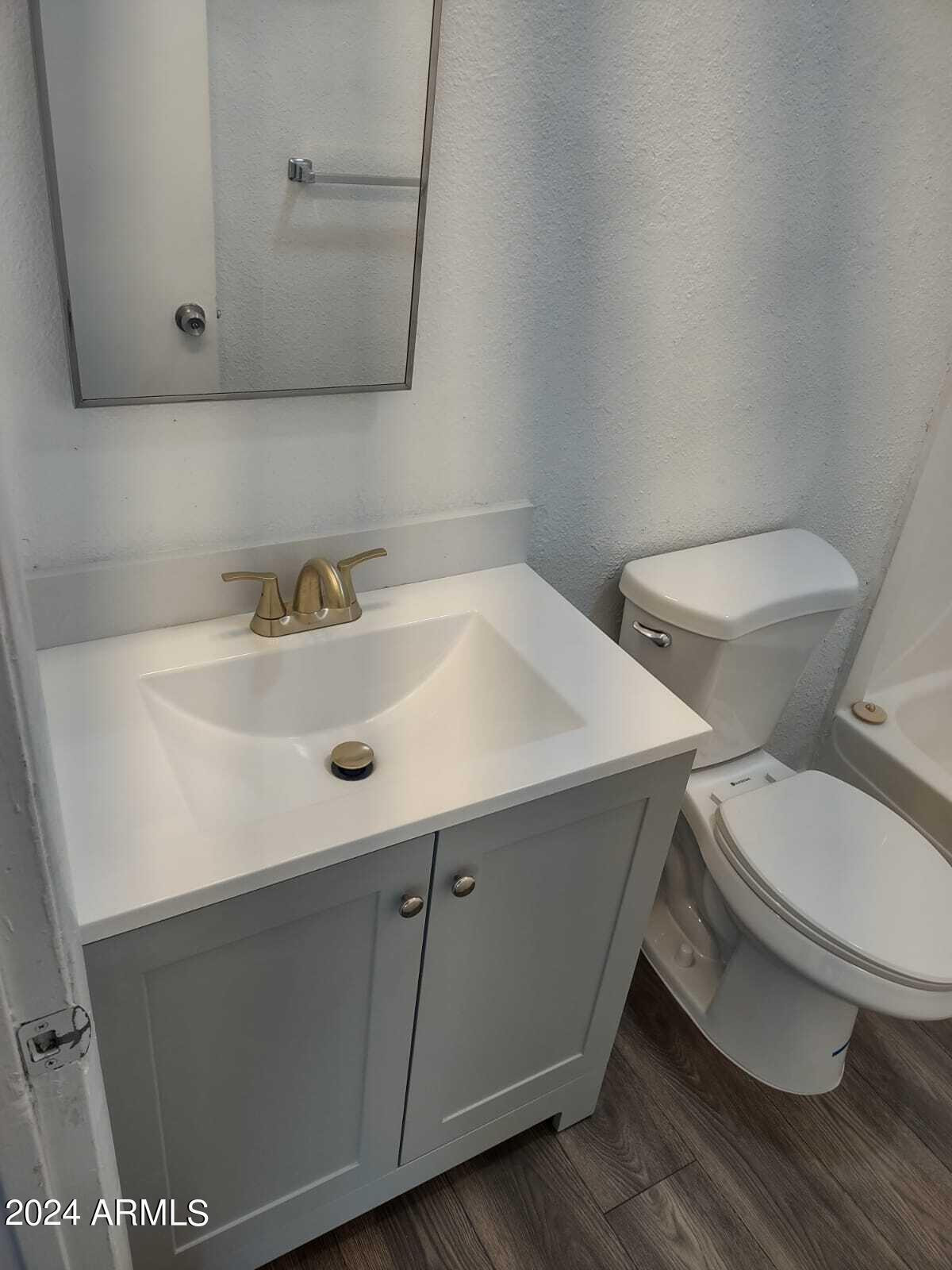 3224 West Jackson Street, Unit 3 Phoenix, AZ 85009 - Photo 7 of 8 a bathroom with a sink and a toilet