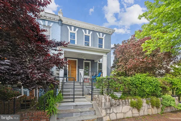 a front view of a house with a garden