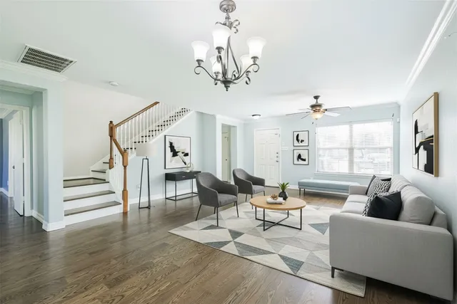 a living room with fireplace furniture and a wooden floor