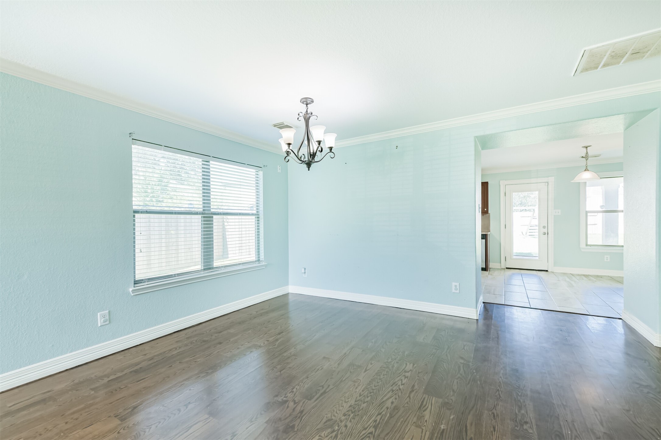 9207 Cribbage Court Houston, TX 77083 - Photo 13 of 47 an empty room with wooden floor and windows