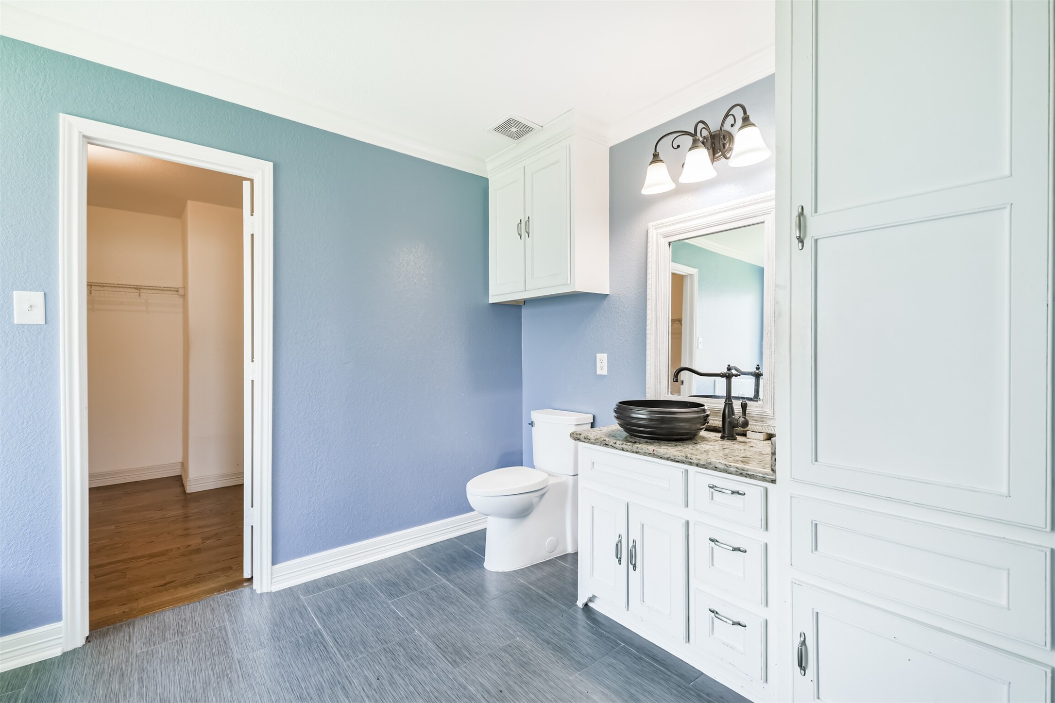 9207 Cribbage Court Houston, TX 77083 - Photo 14 of 47 a bathroom with a granite countertop toilet sink and mirror