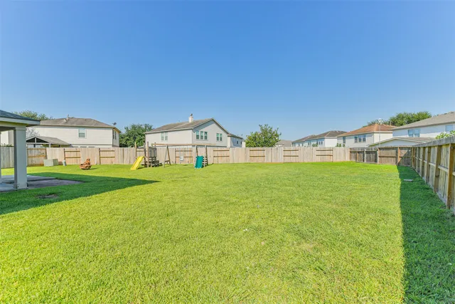 a large kitchen with stainless steel appliances granite countertop a sink counter space cabinets and a large window