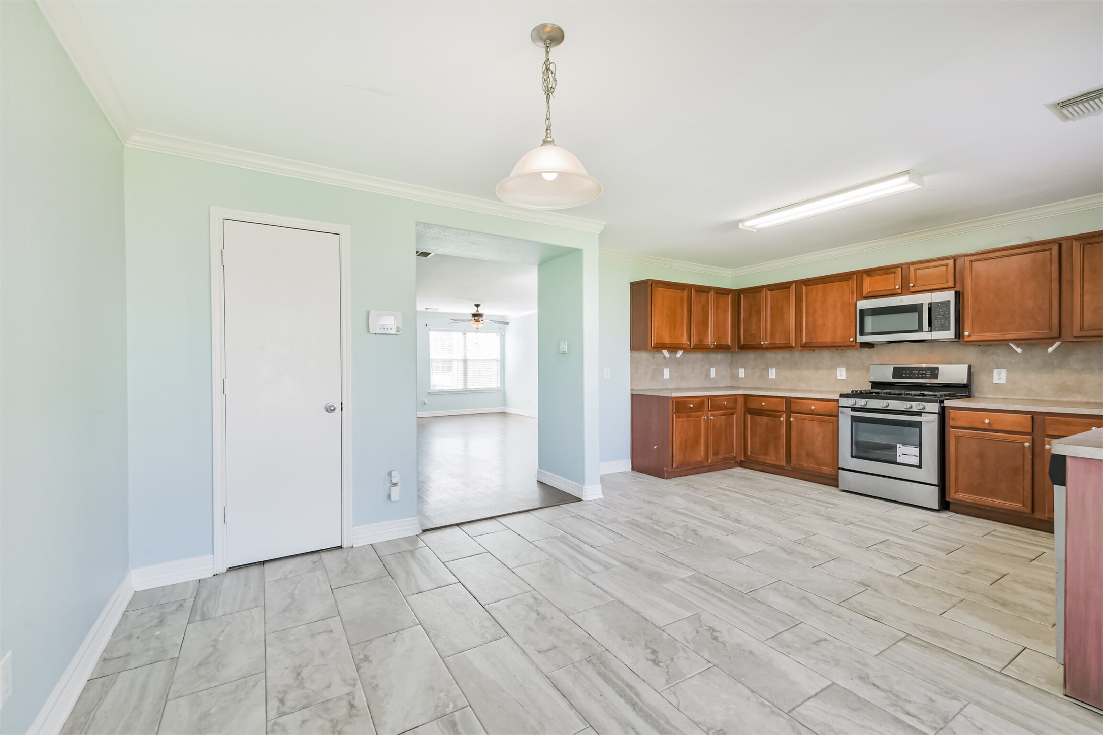 9207 Cribbage Court Houston, TX 77083 - Photo 28 of 47 a large kitchen with granite countertop a stove cabinets and stainless steel appliances