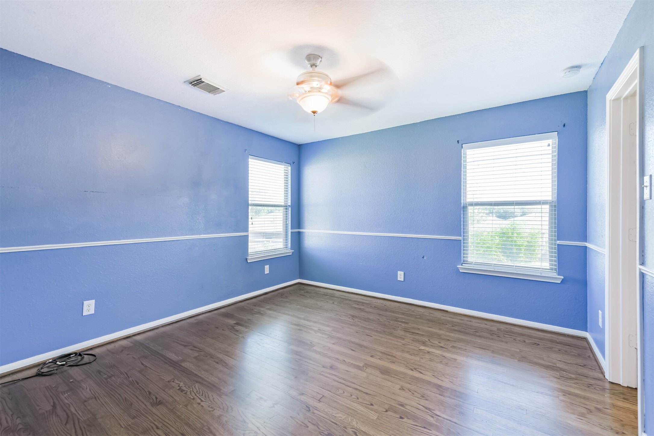 9207 Cribbage Court Houston, TX 77083 - Photo 31 of 47 an empty room with wooden floor and windows