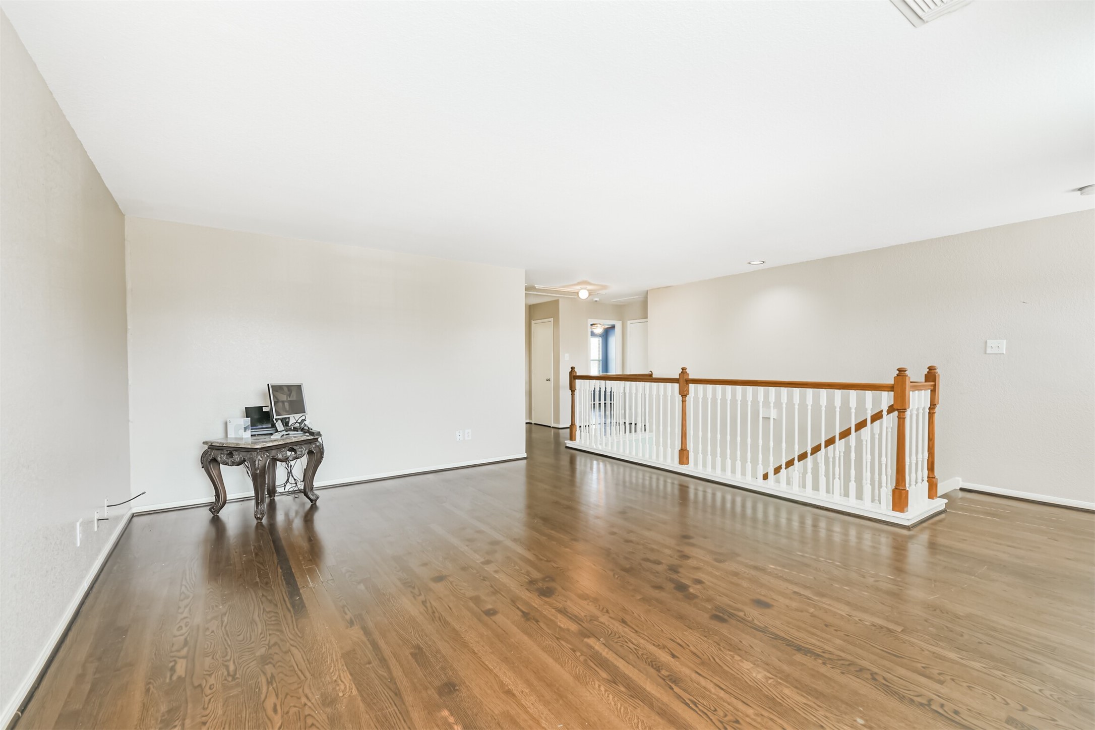 9207 Cribbage Court Houston, TX 77083 - Photo 41 of 47 a view of a hallway with wooden floor and bench