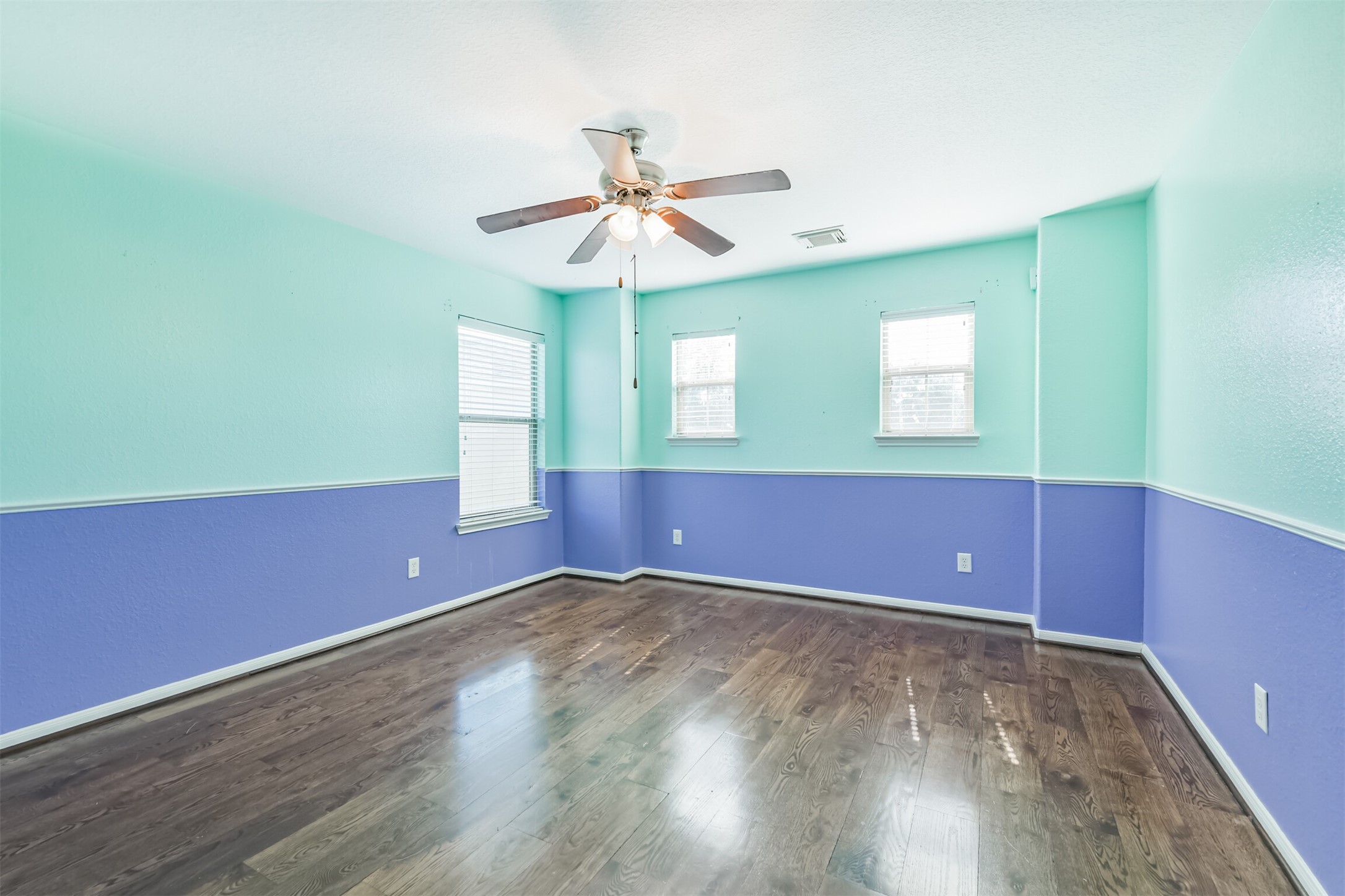 9207 Cribbage Court Houston, TX 77083 - Photo 42 of 47 an empty room with wooden floor and windows
