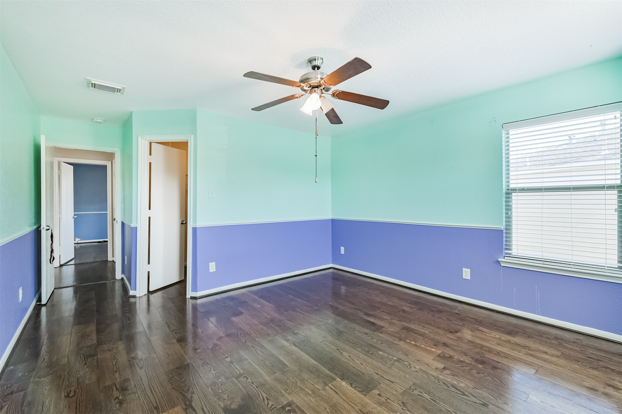 9207 Cribbage Court Houston, TX 77083 - Photo 43 of 47 a view of room with window ceiling fan and hardwood floor