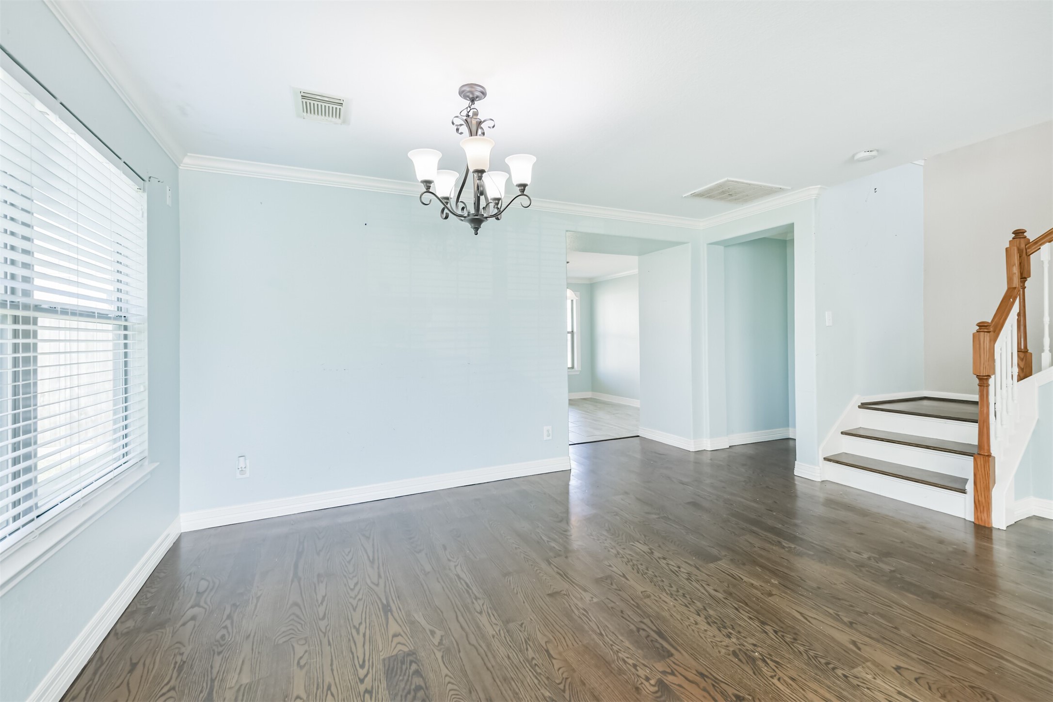 9207 Cribbage Court Houston, TX 77083 - Photo 10 of 47 an empty room with wooden floor cabinet and windows