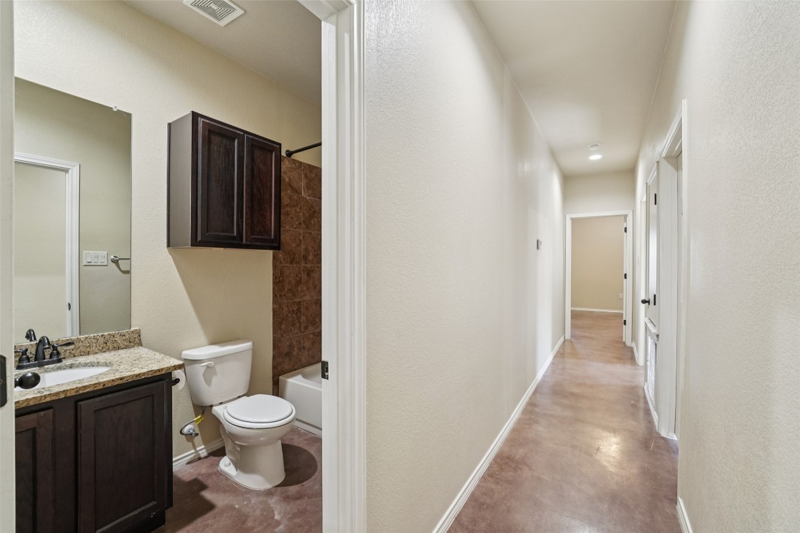 402 Jack Rabbit Lane, Unit B Buda, TX 78610 - Photo 17 of 30 a bathroom with a toilet sink and shower