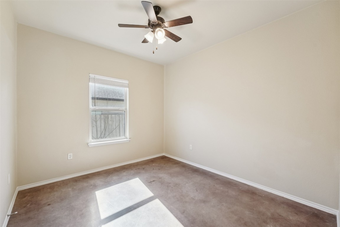 402 Jack Rabbit Lane, Unit B Buda, TX 78610 - Photo 19 of 30 an empty room with windows and fan