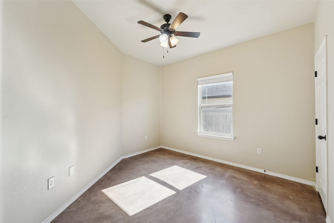 402 Jack Rabbit Lane, Unit B Buda, TX 78610 - Photo 21 of 30 an empty room with a window and a ceiling fan