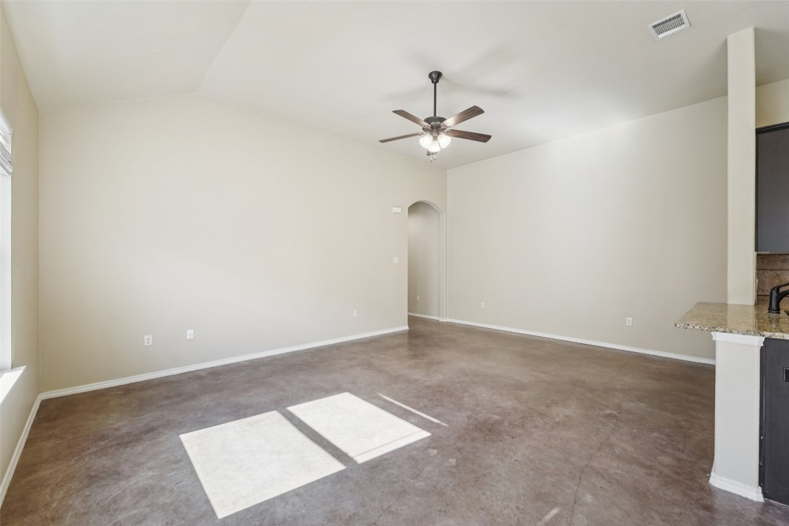 402 Jack Rabbit Lane, Unit B Buda, TX 78610 - Photo 7 of 30 an empty room with a window and a ceiling fan