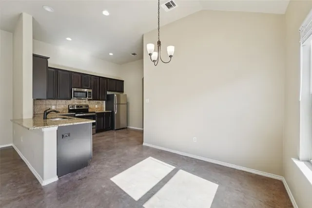 a kitchen with a refrigerator and a sink