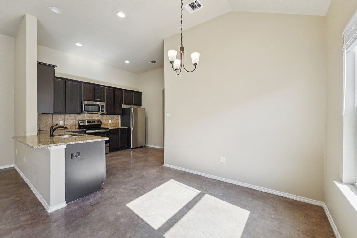 402 Jack Rabbit Lane, Unit B Buda, TX 78610 - Photo 9 of 30 a kitchen with a refrigerator and a sink
