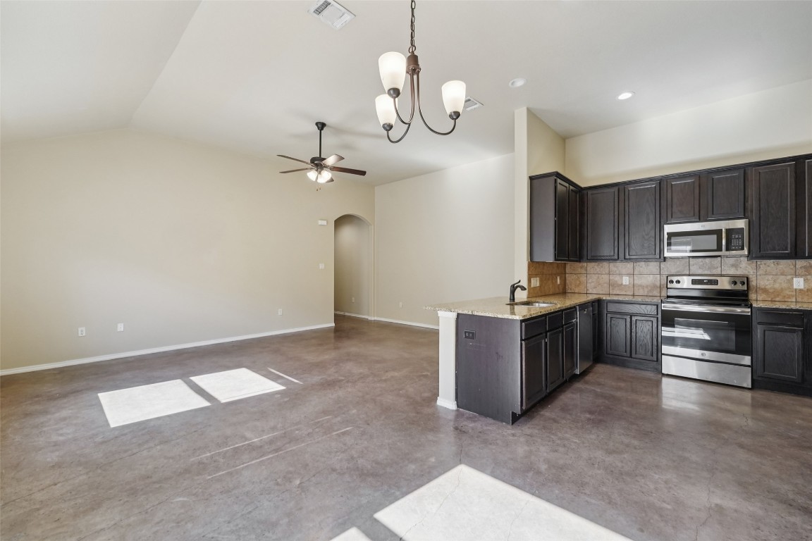 402 Jack Rabbit Lane, Unit B Buda, TX 78610 - Photo 10 of 30 a kitchen with stainless steel appliances granite countertop a refrigerator a stove top oven a sink and dishwasher