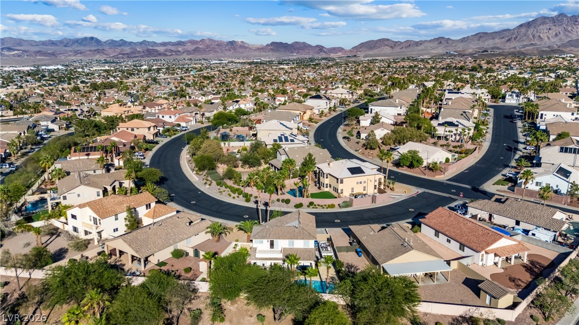 708 Vortex Avenue Henderson, NV 89002 - Photo 59 of 71 An aerial perspective reveals a vibrant neighborhood with diverse homes nestled among desert landscaping and distant mountains.