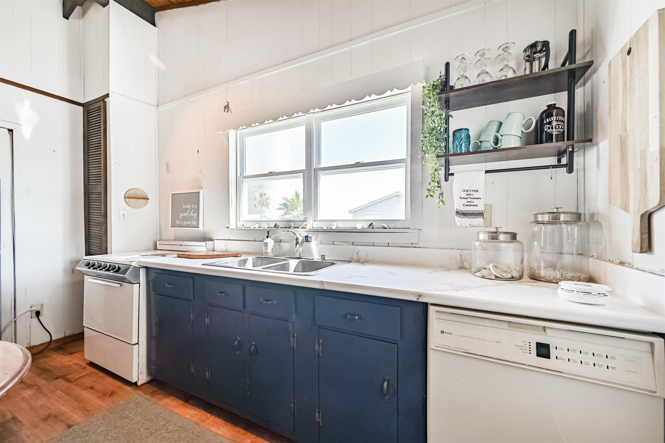 16519 Captain Kidd Road Jamaica Beach, TX 77554 - Photo 11 of 32 a kitchen with stainless steel appliances granite countertop a sink stove and refrigerator