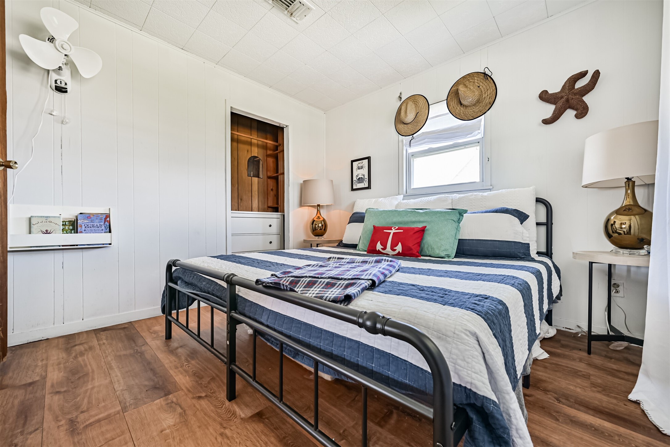 16519 Captain Kidd Road Jamaica Beach, TX 77554 - Photo 14 of 32 a bedroom with a bed and cabinets