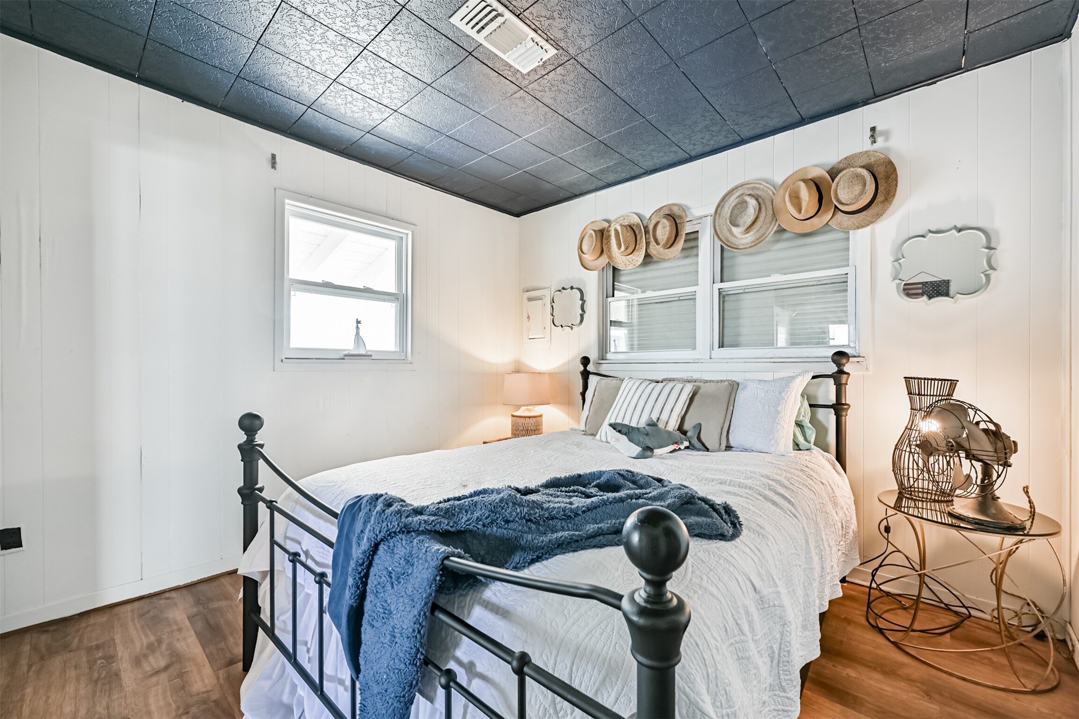 16519 Captain Kidd Road Jamaica Beach, TX 77554 - Photo 18 of 32 a bedroom with a bed and wooden floor