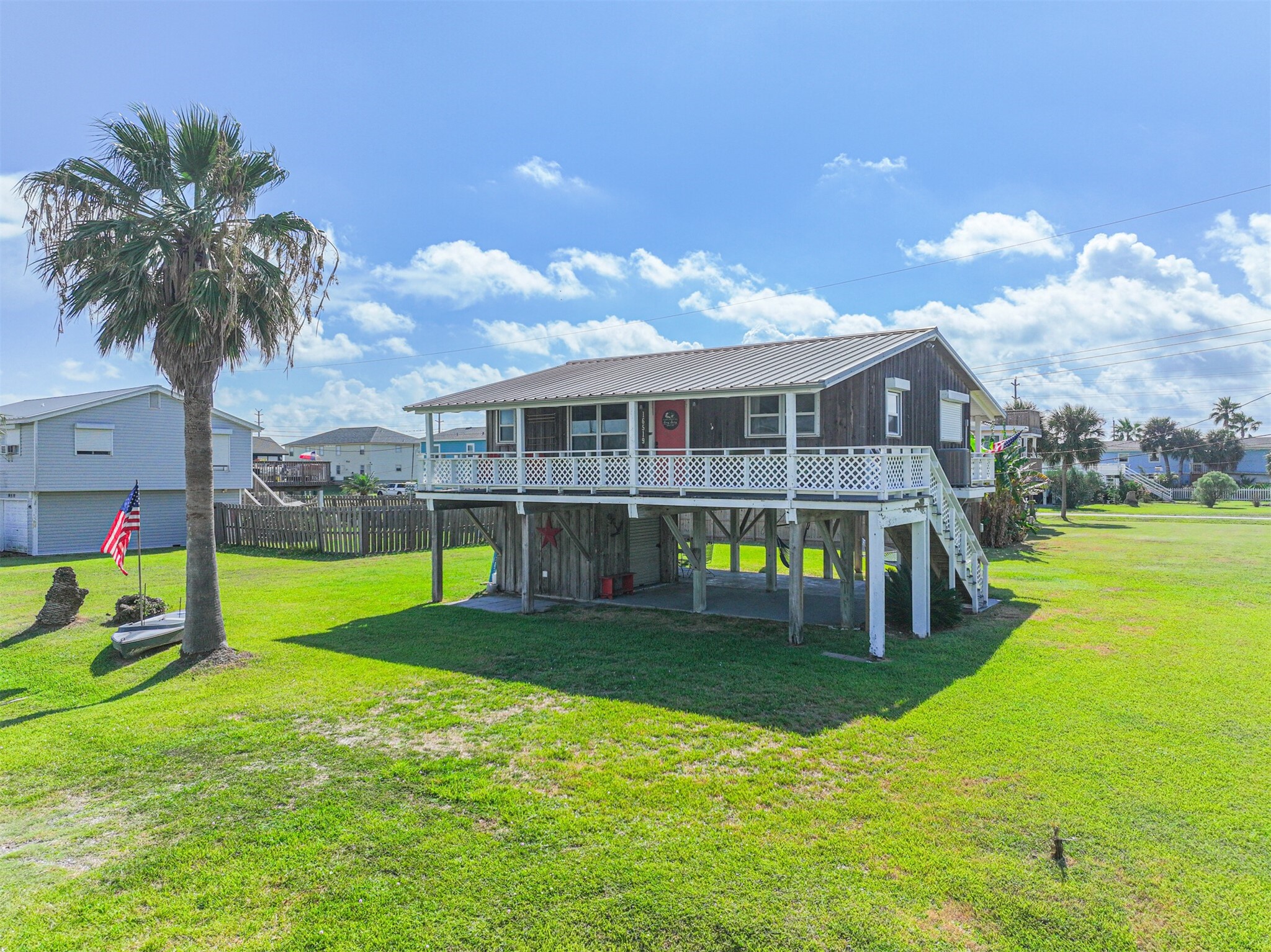 16519 Captain Kidd Road Jamaica Beach, TX 77554 - Photo 2 of 32 a view of a house with swimming pool and porch