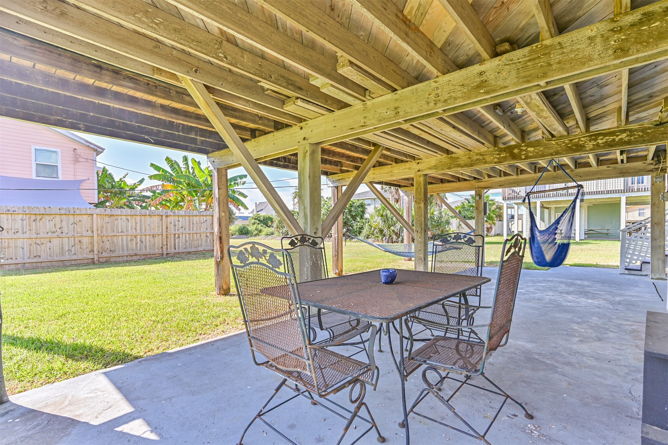 16519 Captain Kidd Road Jamaica Beach, TX 77554 - Photo 28 of 32 a view of a patio with a table chairs and a barbeque