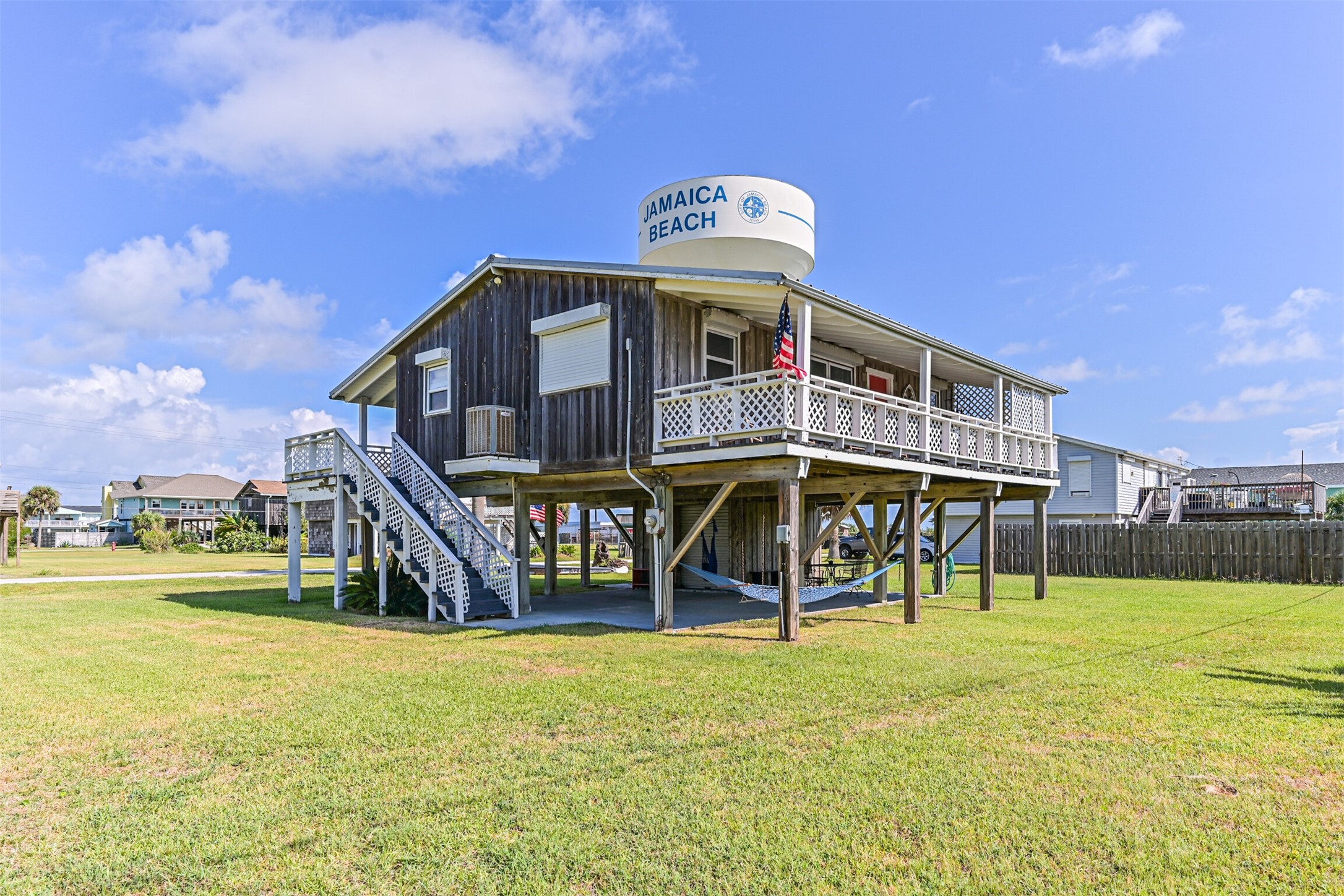 16519 Captain Kidd Road Jamaica Beach, TX 77554 - Photo 30 of 32 a front view of a building with garden