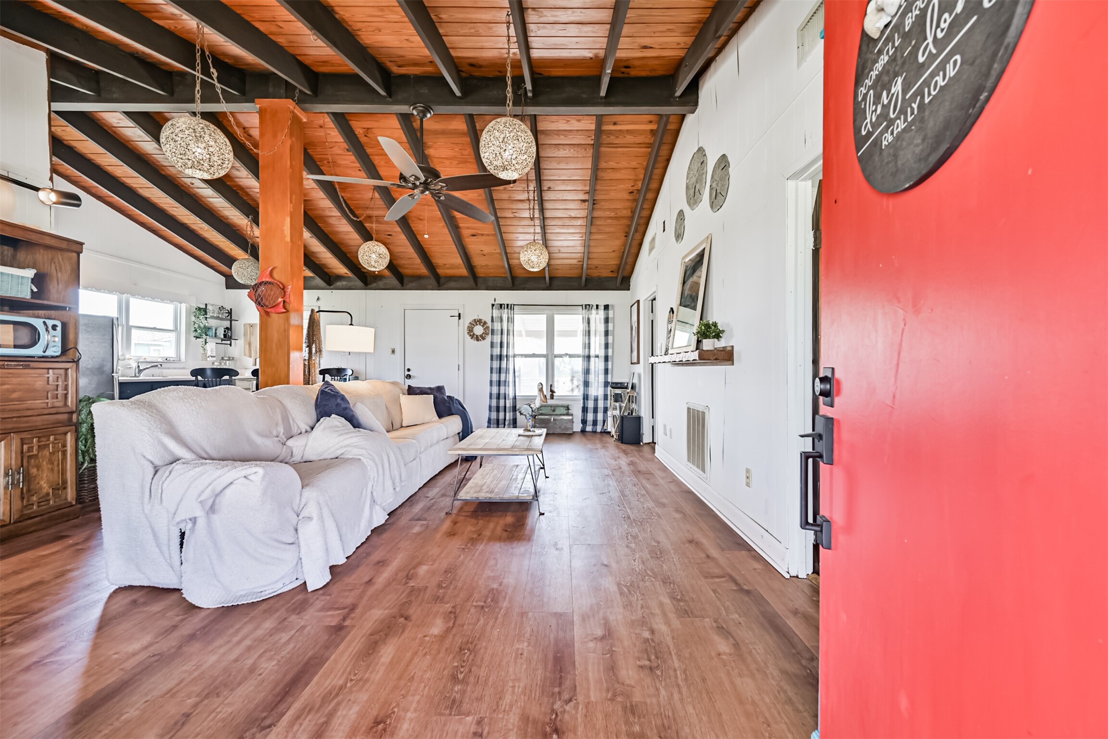 16519 Captain Kidd Road Jamaica Beach, TX 77554 - Photo 3 of 32 a spacious bedroom with wooden floors and a bed