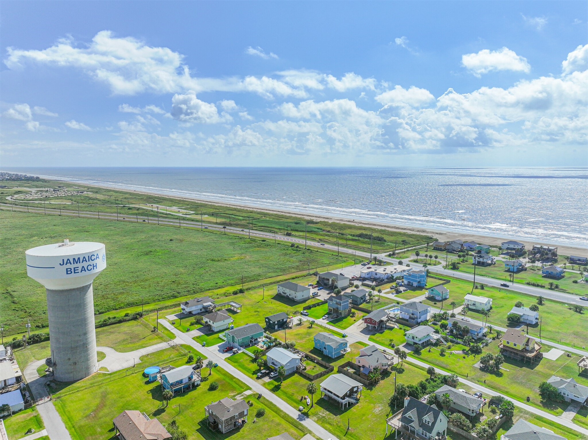 16519 Captain Kidd Road Jamaica Beach, TX 77554 - Photo 31 of 32 a view of a swimming pool with a yard