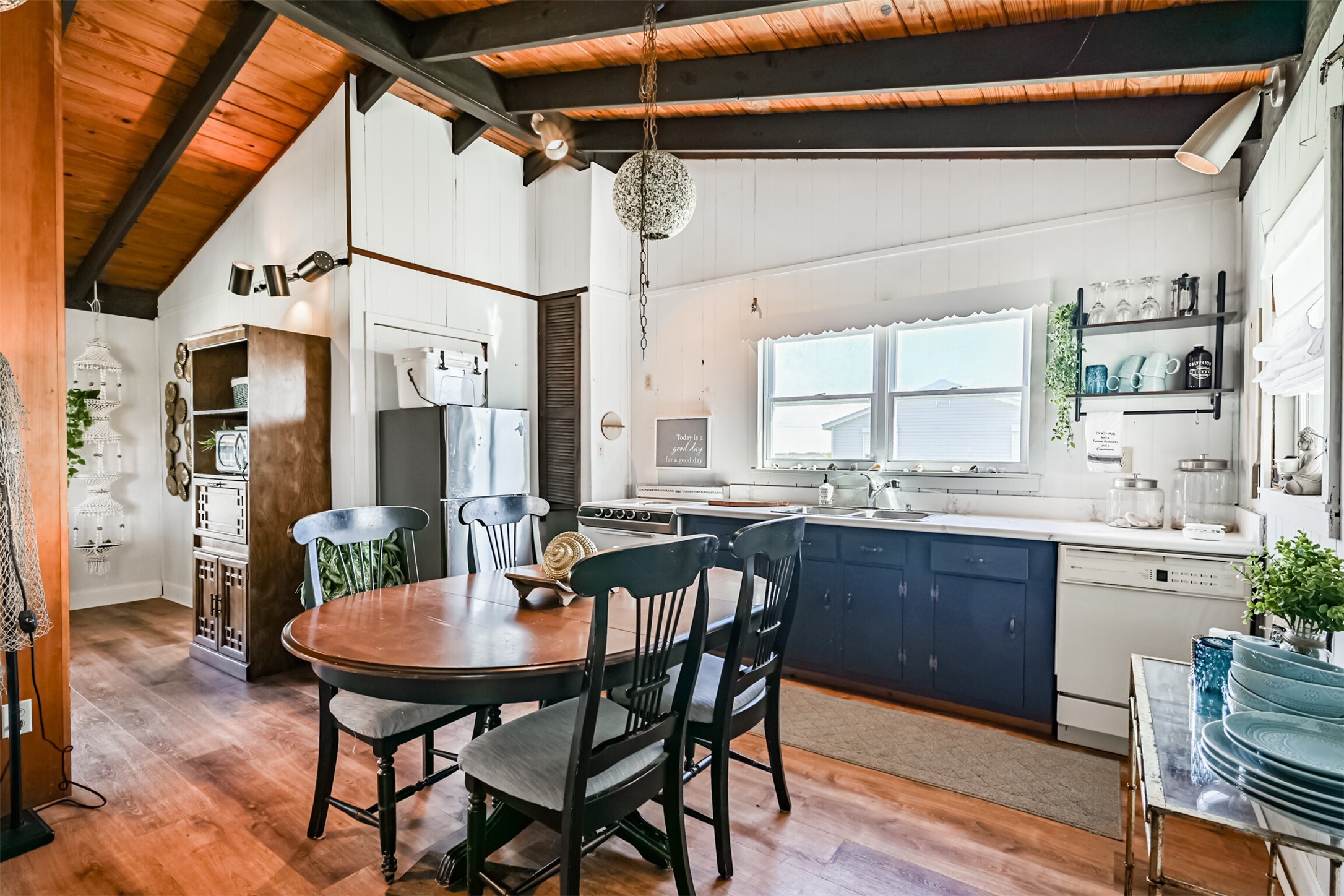 16519 Captain Kidd Road Jamaica Beach, TX 77554 - Photo 8 of 32 a dining room with a wooden table and chairs