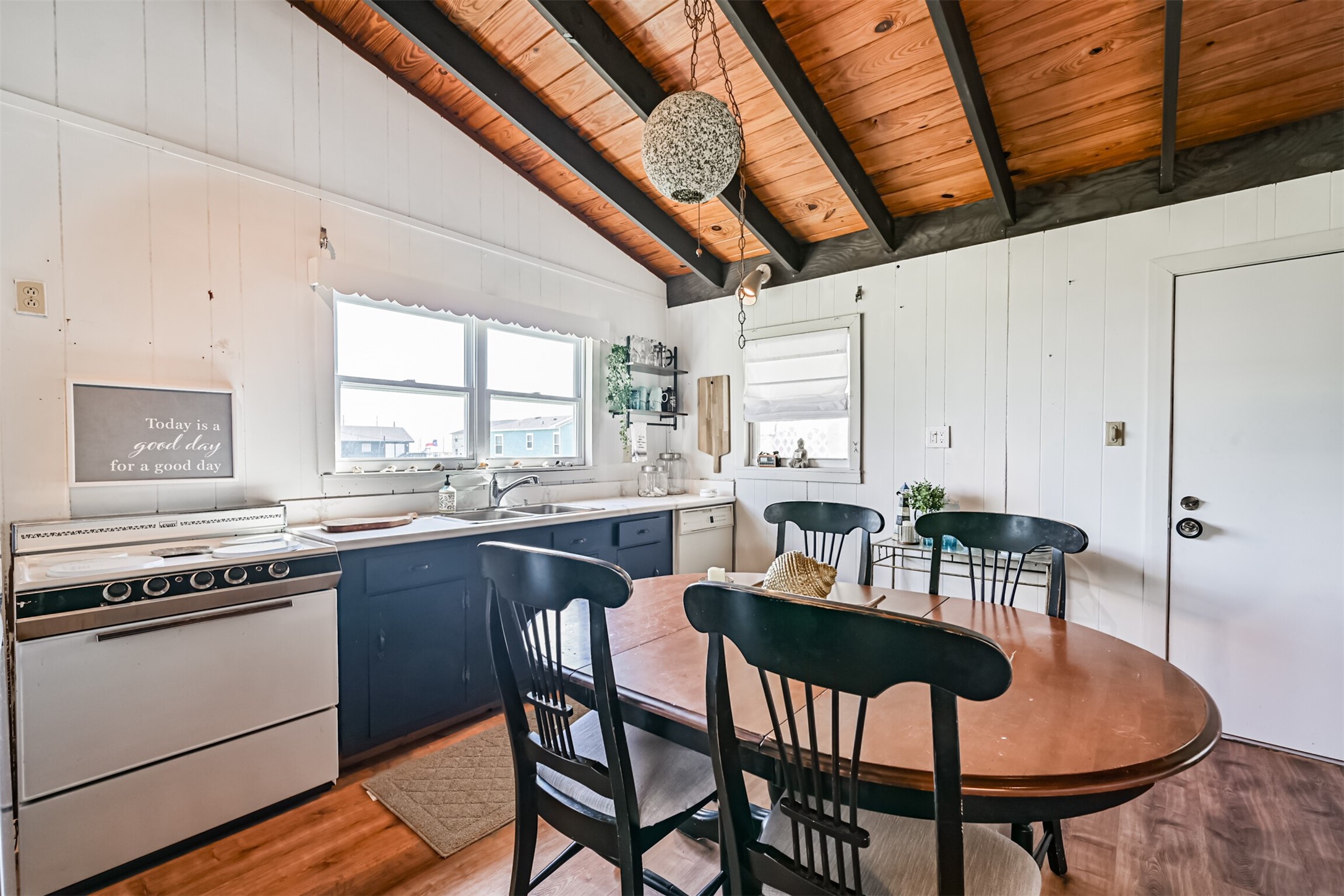 16519 Captain Kidd Road Jamaica Beach, TX 77554 - Photo 9 of 32 a kitchen with stainless steel appliances granite countertop a stove a sink dishwasher and cabinets